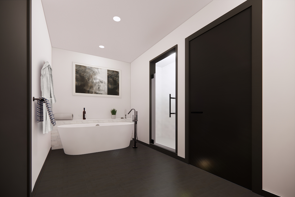 A luxe bathroom in a residence at The Henry in Bozeman, featuring a white soaking tub and black trim.