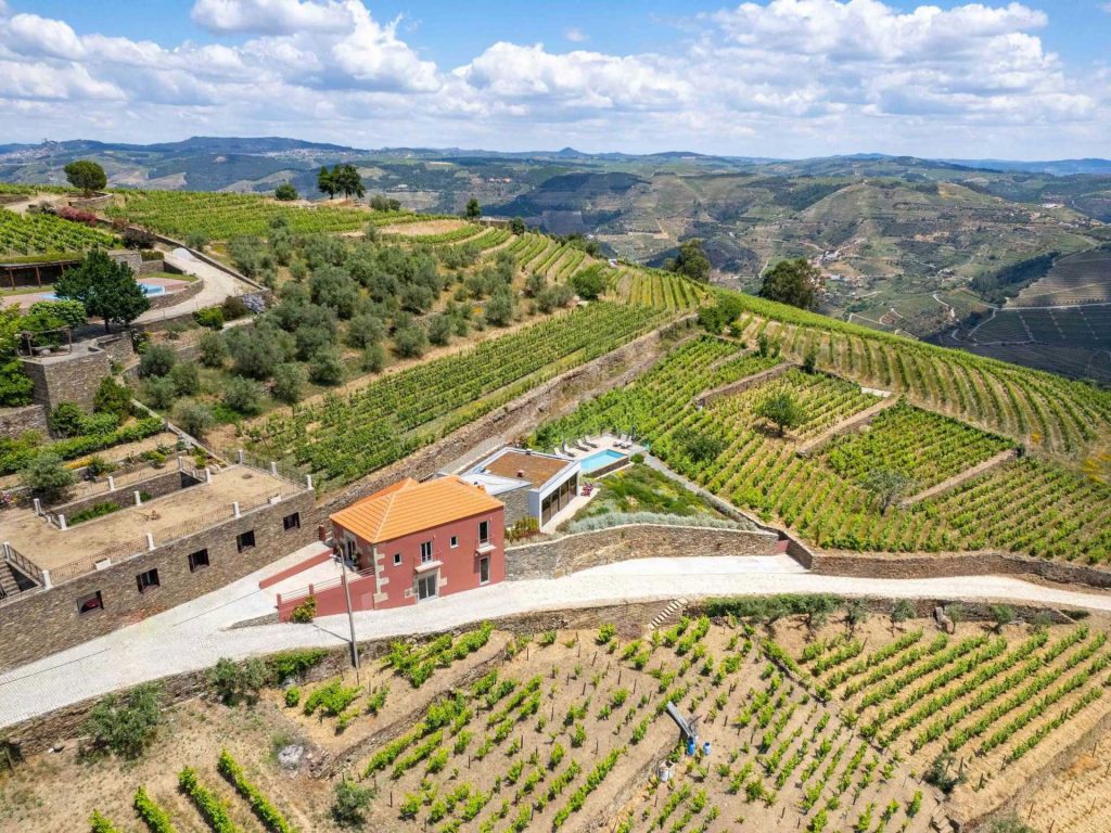 Nestled in the heart of the UNESCO-classified Alto Douro wine region, this modern farmhouse is surrounded by a timeless Portuguese landscape of picturesque mountains, terraced vineyards, olive groves and a meandering river.