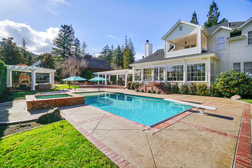 The glimmering pool within 969 Forest Lane's dreamy backyard.