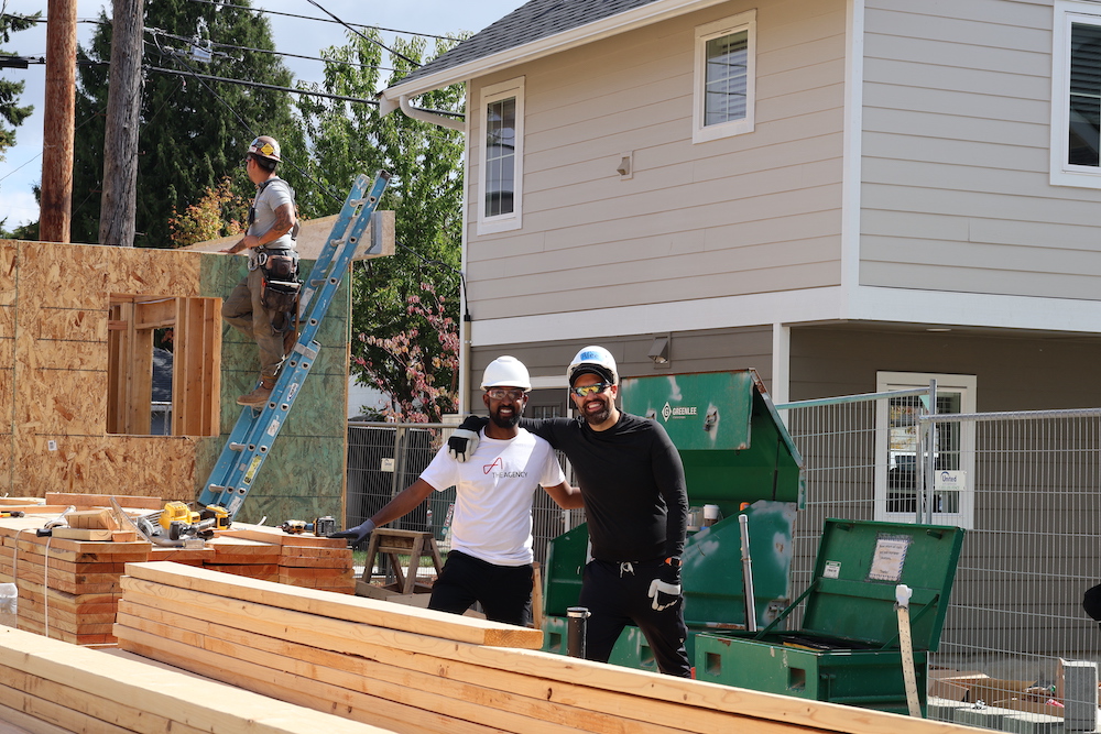 The Agency members smiling together as they helped build a home for a local family in need.